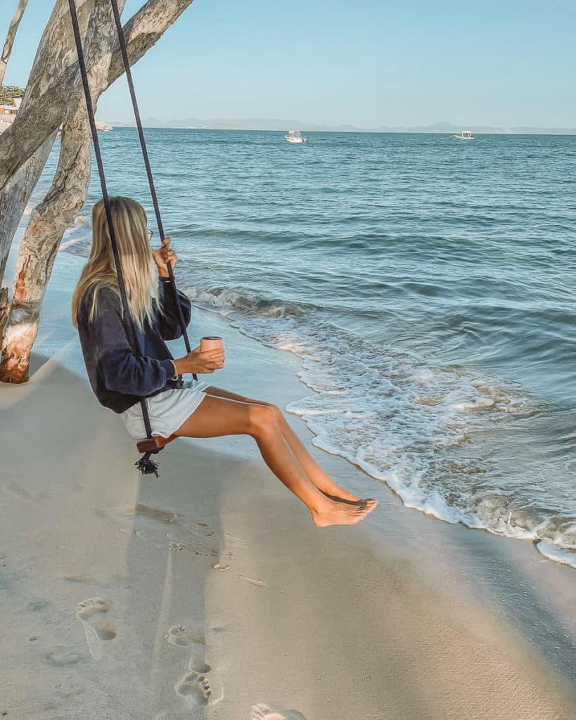 20 Amazing Things to do in Great Keppel Island, Queensland 8 Girl swinging on swing at the beach on Great Keppel Island