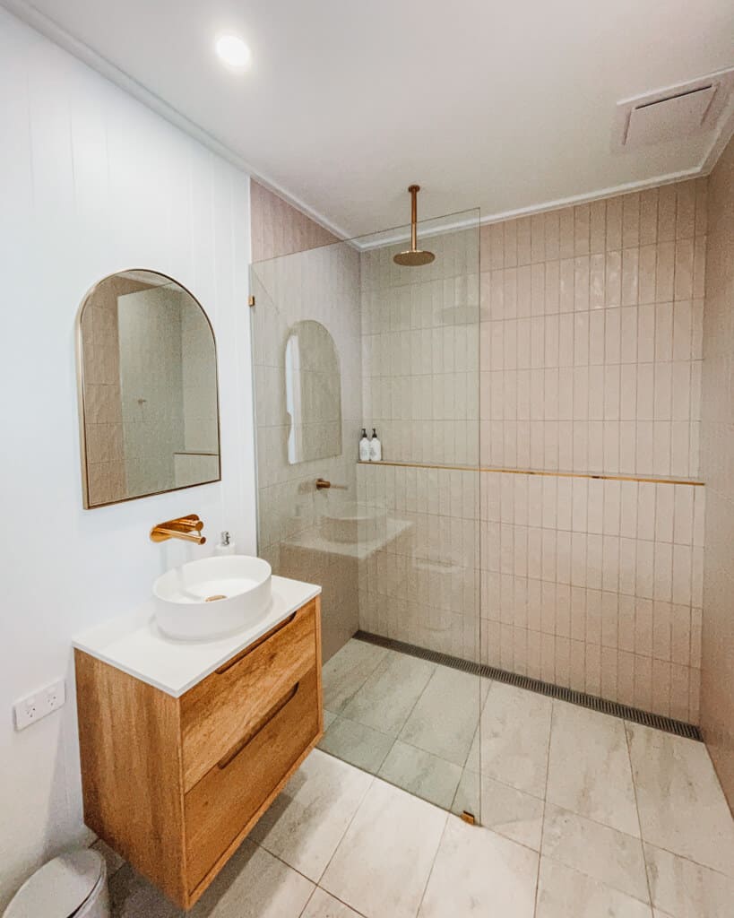 5 Best Hostels in Noosa 3 A private bathroom with pink tiles at Bounce Noosa