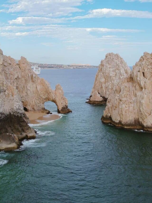 An aerial shot of El Arco in Cabo San Lucas, a unique rock formation like an arch in the ocean.