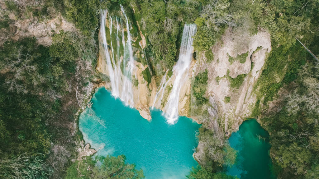 Drone shot of Cascadas de Minas Viejas, two waterfalls flowing into a large blue pool