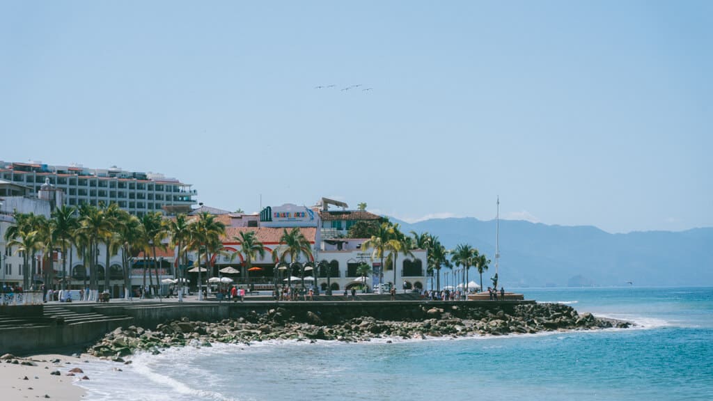 The Puerto Vallarta Malecon, a seafront promenade winding around the coast lined with palm trees