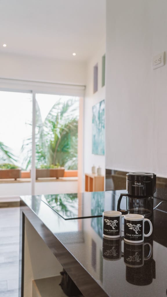 Casa Tortugas Boutique Hotel - Sustainable Accommodation in Cancun 11 Two coffee cups with Casa Tortugas Boutique Hotel printed on them