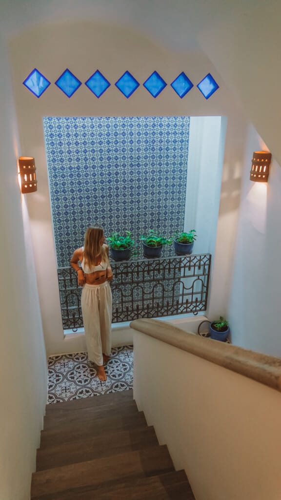 Casa Tortugas Boutique Hotel - Sustainable Accommodation in Cancun 25 Sally leaning against a patterned wall in the stairwell at Casa Tortugas Boutique Hotel