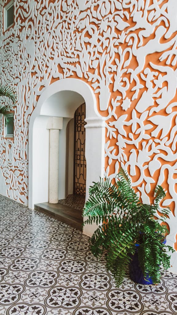 Casa Tortugas Boutique Hotel - Sustainable Accommodation in Cancun 15 An orange wall with abstract shapes at Casa Tortugas Boutique Hotel