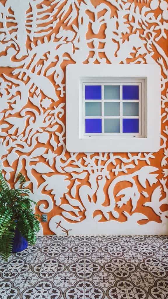 Casa Tortugas Boutique Hotel - Sustainable Accommodation in Cancun 16 An orange wall with abstract shapes at Casa Tortugas Boutique Hotel