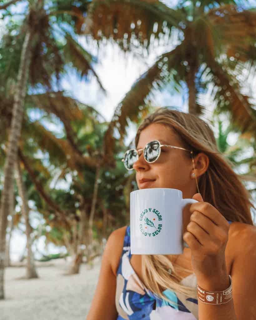 Glamping at Hotel Cielo y Selva in the Sian Ka'an Biosphere Reserve 35 Sally holding a coffee cup with a Hotel Cielo y Selva logo printed on it