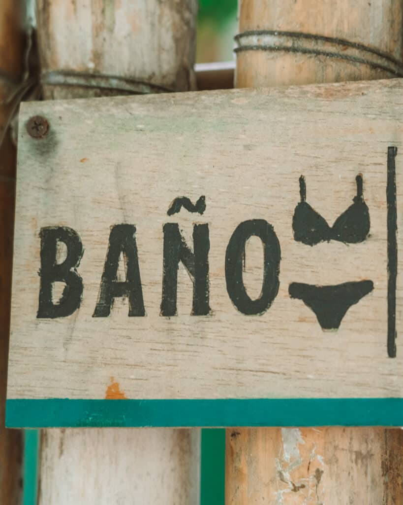 Glamping at Hotel Cielo y Selva in the Sian Ka'an Biosphere Reserve 18 A painted sign saying baño, with a bikini symbol