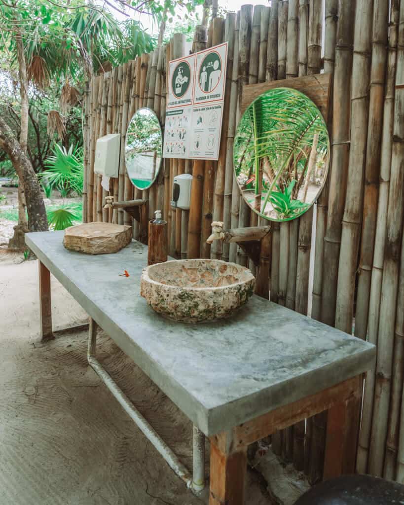 Glamping at Hotel Cielo y Selva in the Sian Ka'an Biosphere Reserve 17 An outdoor bathroom vanity with two mirrors and two sinks