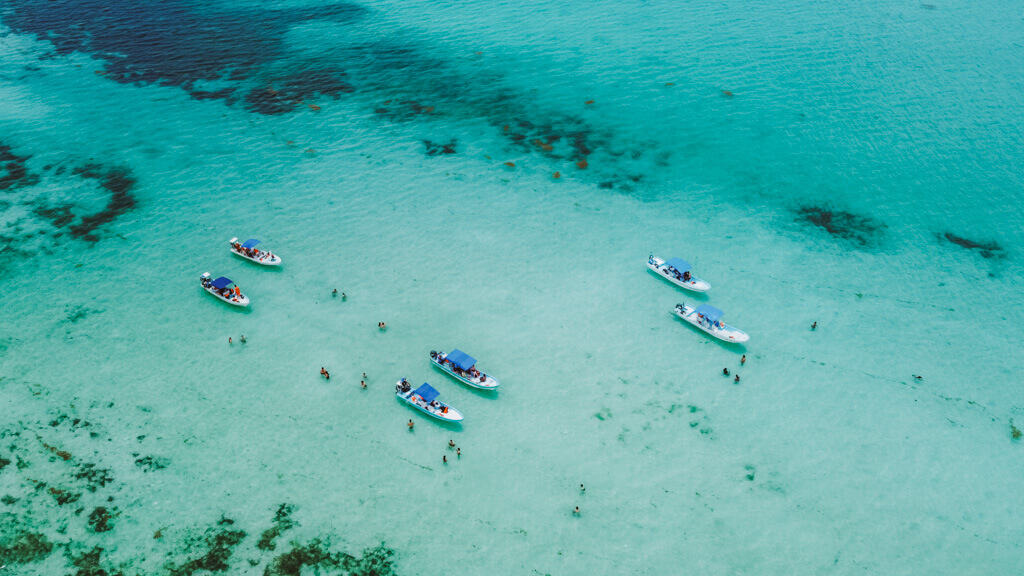 Glamping at Hotel Cielo y Selva in the Sian Ka'an Biosphere Reserve 36 A drone shot of 6 boats in clear blue water inside the Sian Ka'an Biosphere Reserve