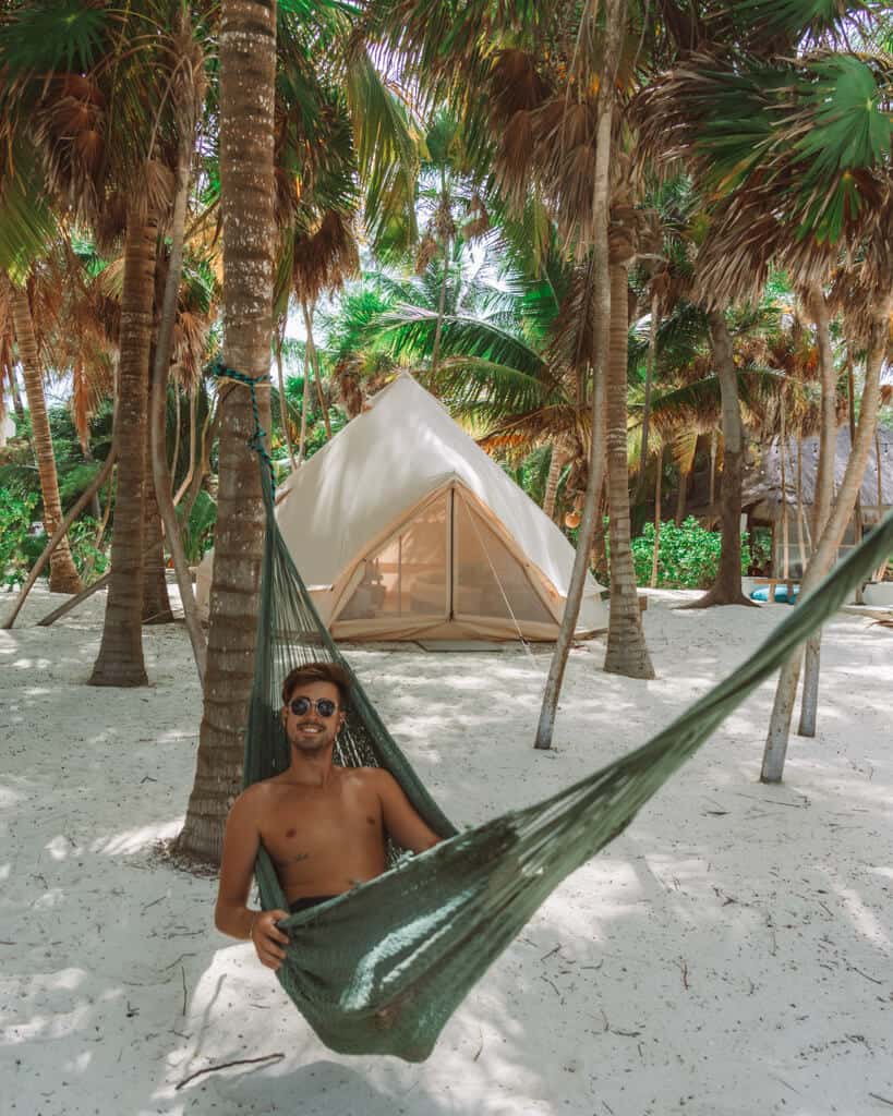 Glamping at Hotel Cielo y Selva in the Sian Ka'an Biosphere Reserve 54 Brayden lying in a green hammock in front of a glamping tent