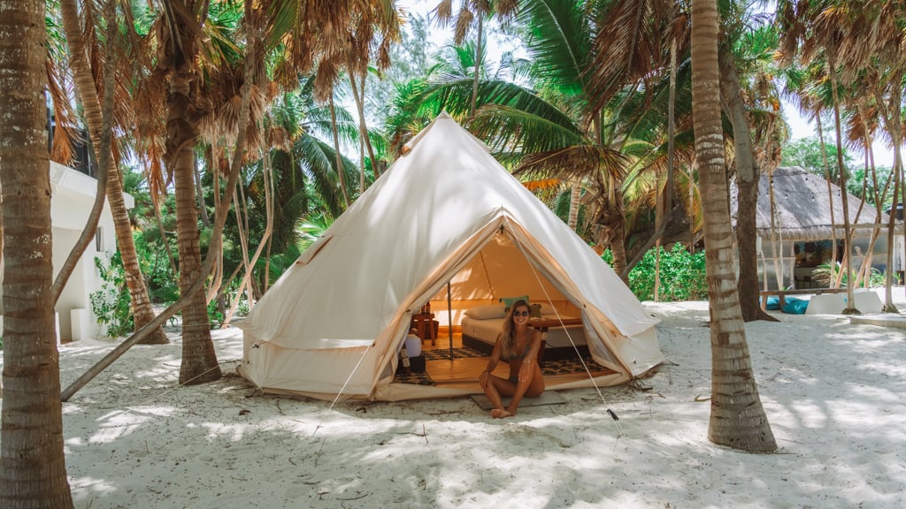 Glamping at Hotel Cielo y Selva in the Sian Ka'an Biosphere Reserve 9 Sally sitting at the entrance to a glamping tent, set up under palm trees at Hotel Cielo y Selva