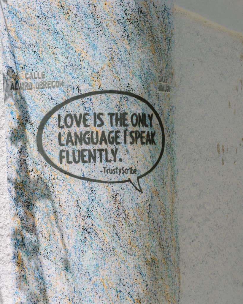 Street art in San Jose del Cabo with the words 'love is the only language I speak fluently' 