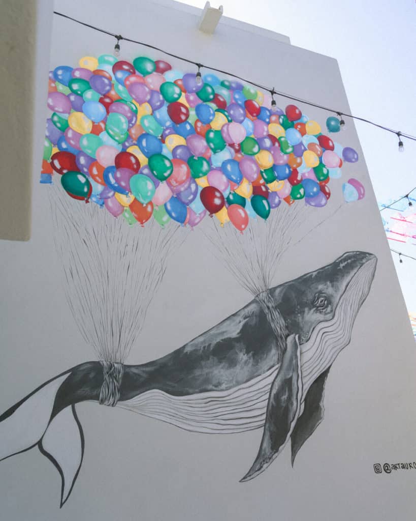 A painting in San Jose del Cabo of a humpback whale with colourful balloons tied to it