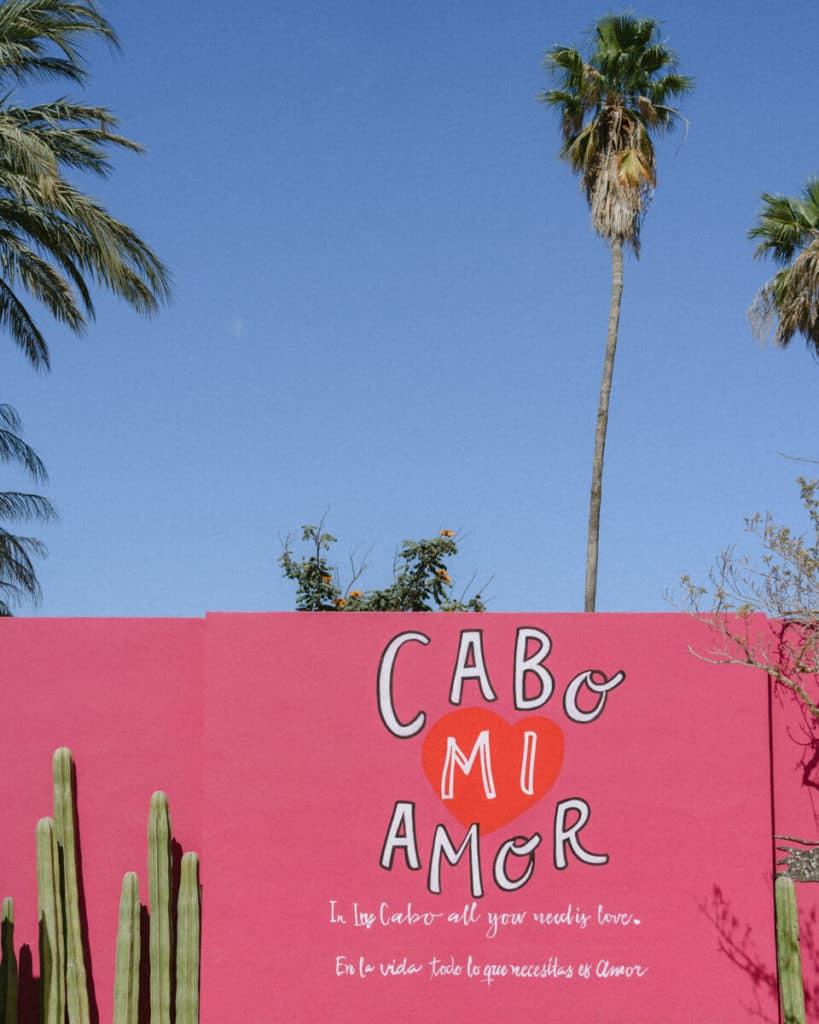 A pink painted wall in San Jose del Cabo with the words 'Cabo Mi Amor' around a love heart