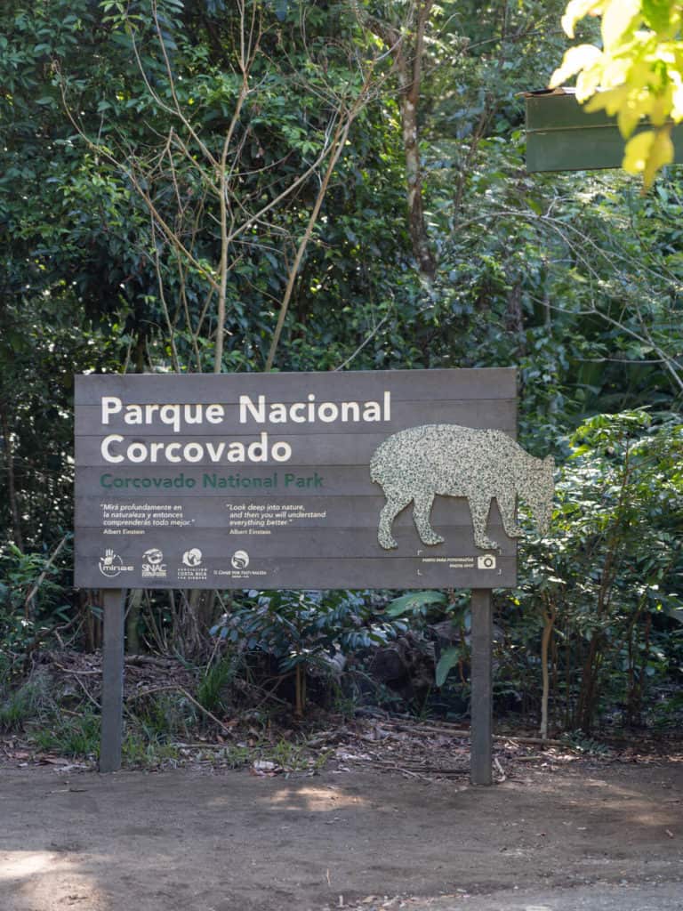 A sign in a clearing in the forest saying 'Parque Nacional Corcovado'