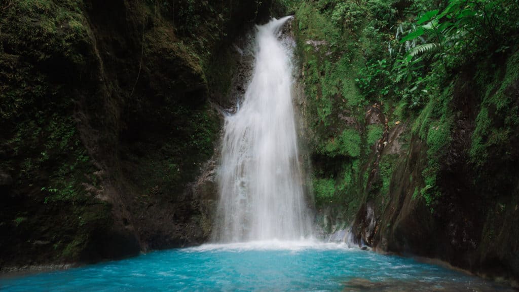 Bajos del Toro Travel Guide: Costa Rica's Waterfall Wonderland 10 A waterfall falling into bright blue pool at the Blue Falls of Costa Rica in Bajos del Toro