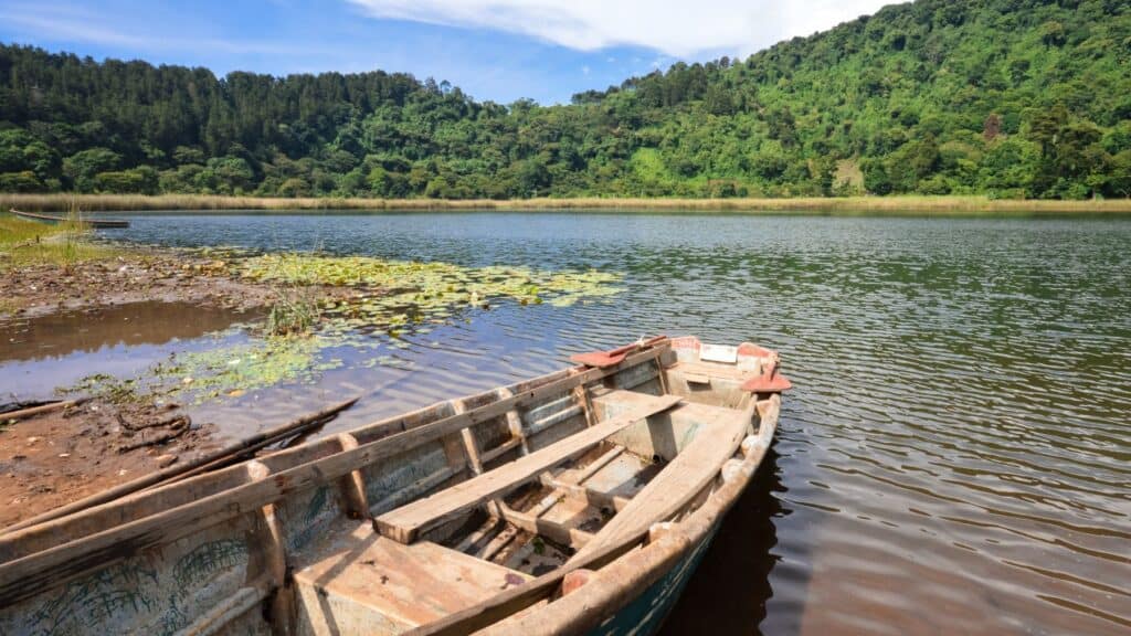 Ultimate Guide to the Ruta de las Flores, El Salvador 56 A serene view of Laguna Verde in Ruta de las Flores, El Salvador, with dense green forest reflecting on the calm water.