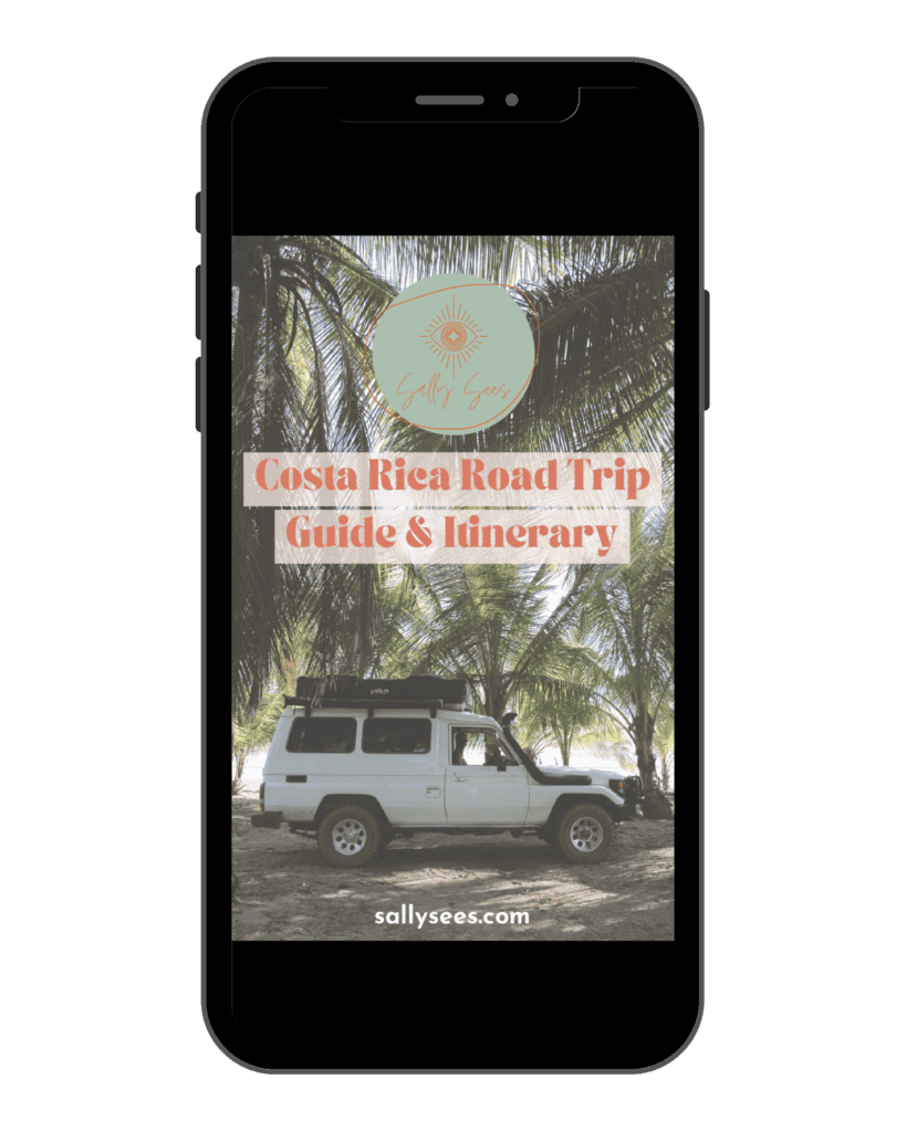 A Canva graphic of an iPhone with the cover of a Costa Rica Road Trip Guide & Itinerary on the screen, with a photo of a white 4WD car amongst palm trees and the Sally Sees logo