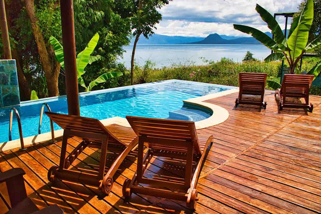 Lake Atitlan Travel Guide: Everything You Need to Know 21 Infinity pool and wooden deck overlooking Lake Atitlán at Casa Lobo Bungalows in San Pedro La Laguna, Guatemala.