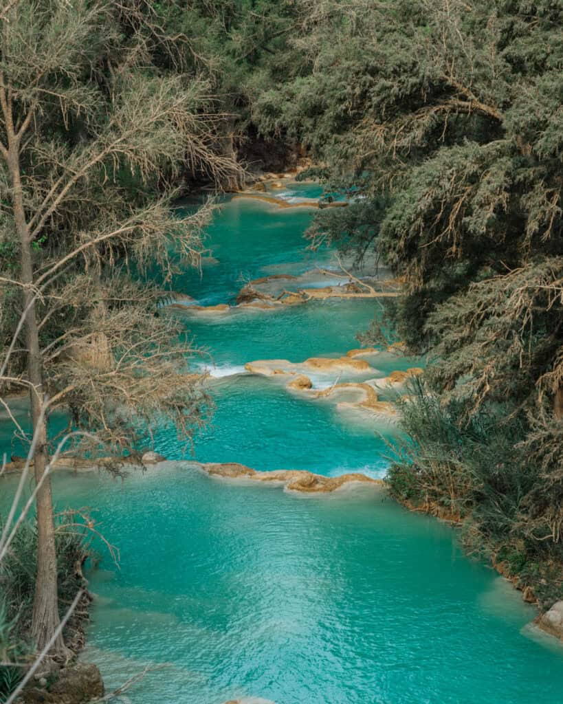 Cascadas El Chiflon: Without a Tour + Overnight Stay 7 The vibrant turquoise river at Cascadas El Chiflon, tumbling over small limestone bridges.