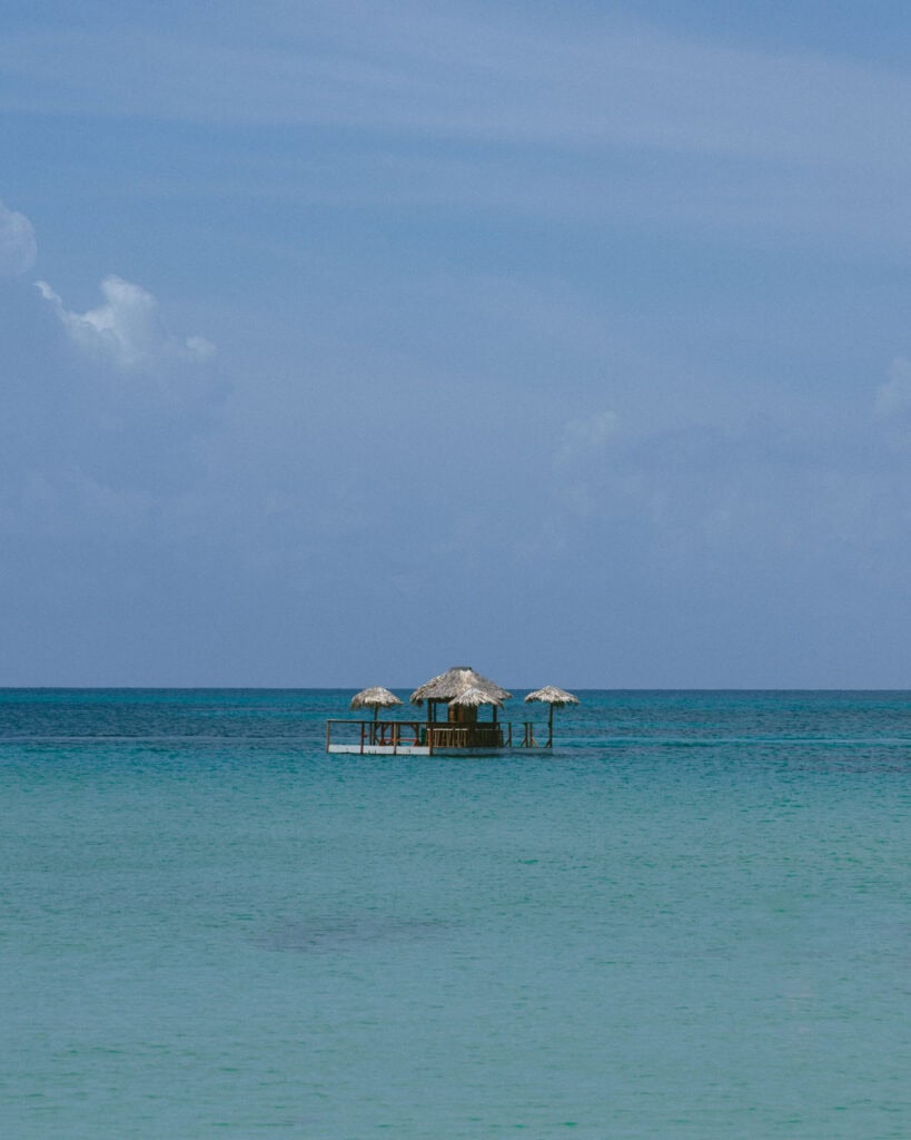 Big Corn Island, Nicaragua: The Underrated Corn Island 36 A unique floating bar with thatched roofs sits in the middle of the calm blue waters off Big Corn Island, providing a secluded tropical escape.
