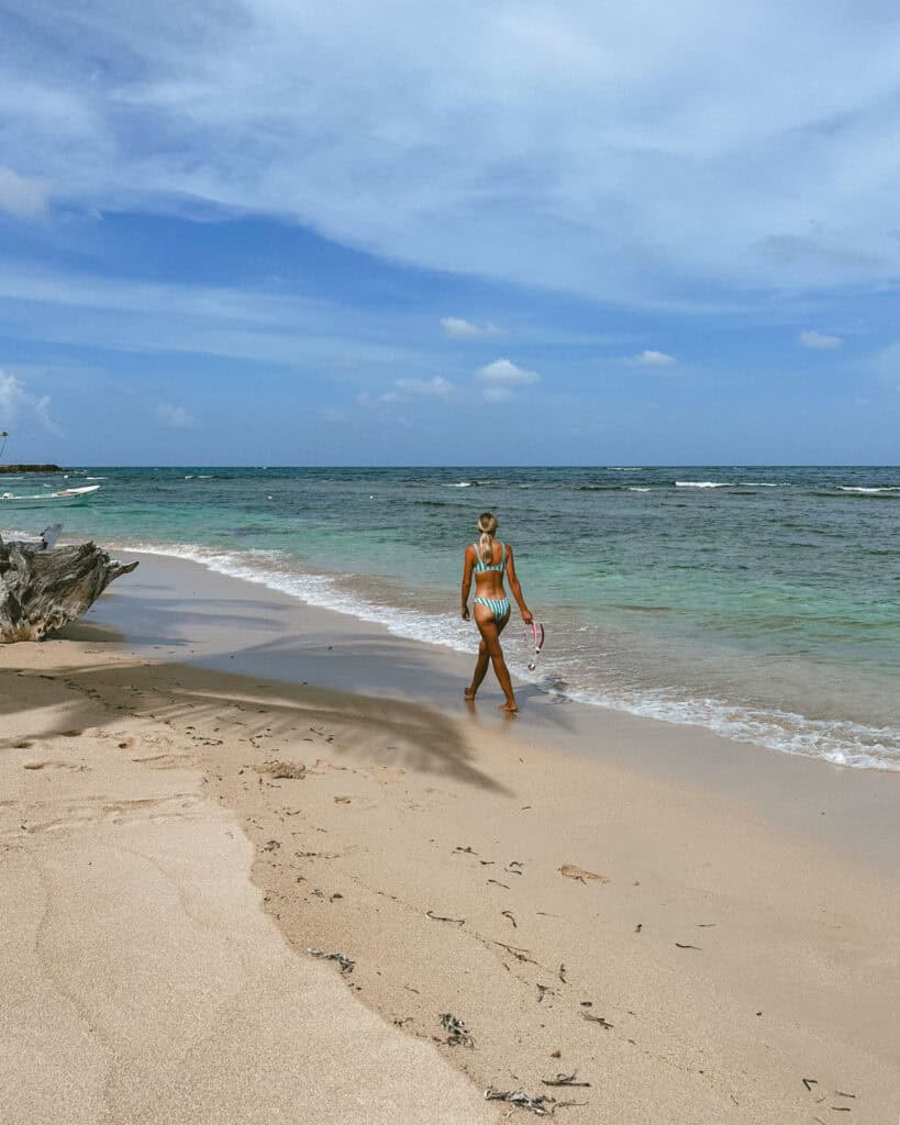 Corn Islands Nicaragua: Paradise on Big & Little Corn 5 Sally walking towards the water on Silver Sand Beach, holding her snorkel mask with a peaceful ocean backdrop.