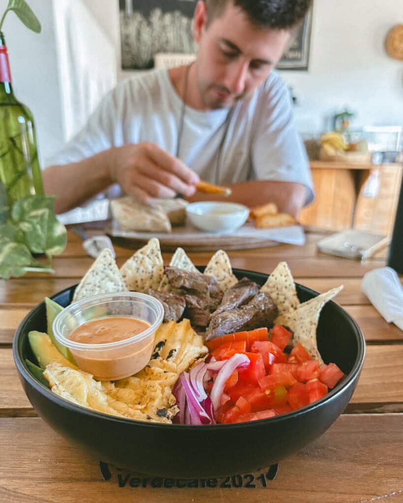 Granada, Nicaragua Travel Guide: Our Honest Thoughts 25 A hearty bowl of grilled steak, fresh veggies, tortilla chips, and a dipping sauce, with Brayden seated in the background at Verde Cafe.