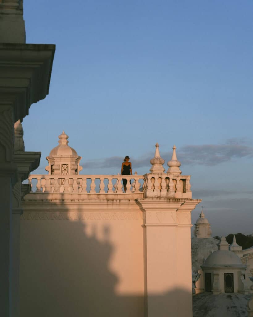 Leon, Nicaragua Travel Guide: The City of Revolution 6 Sally standing on the rooftop balustrade of León Cathedral, overlooking the domes and enjoying the sunset view.