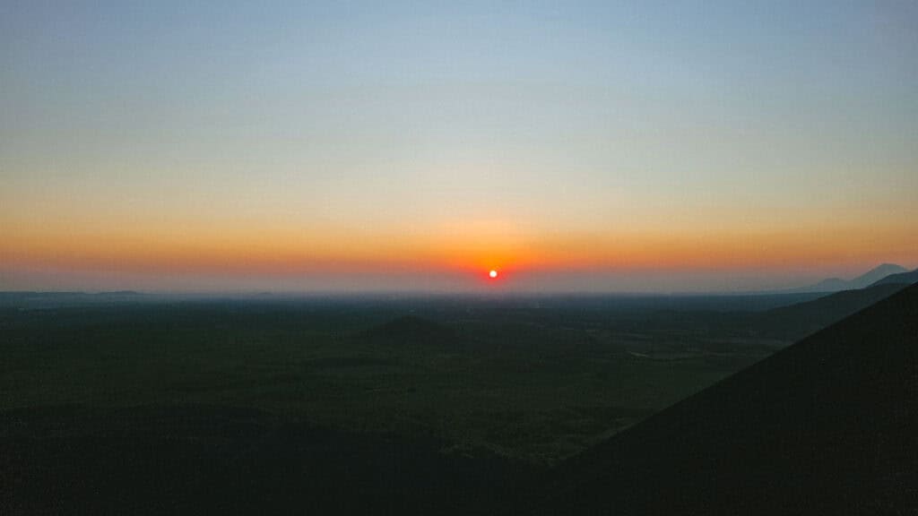 Epic Volcano Boarding in Nicaragua at Cerro Negro Volcano 11 A serene view of the sunset with soft colors blending into the horizon, highlighting the natural beauty of Cerro Negro in Leon, Nicaragua.