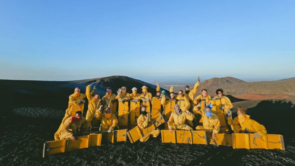 Epic Volcano Boarding in Nicaragua at Cerro Negro Volcano 6 Another shot of the tour group celebrating their volcano boarding adventure on Cerro Negro's slopes in Leon, Nicaragua.