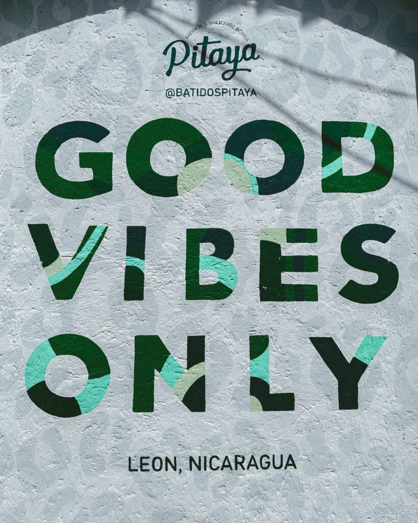 Leon, Nicaragua Travel Guide: The City of Revolution 28 A colorful mural at Pitaya smoothie bar in León, Nicaragua, featuring the phrase "Good Vibes Only" in an array of green tones.