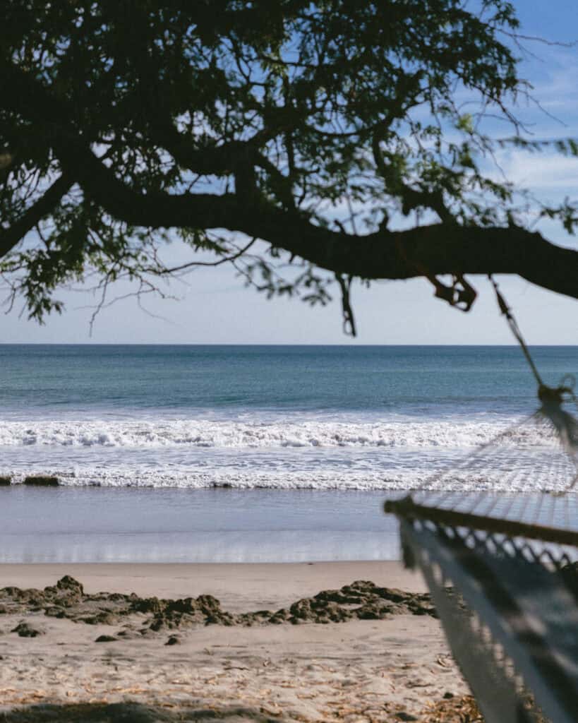 Popoyo, Nicaragua Travel Guide: Surf, Sand and Sunsets 25 A hammock gently swinging under tree branches, overlooking the tranquil waves on Playa Popoyo.