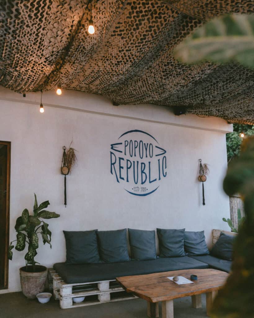 Popoyo, Nicaragua Travel Guide: Surf, Sand and Sunsets 32 A cozy seating area at Popoyo Republic featuring wooden furniture and a sign reading "Popoyo Republic, Est. 2020."