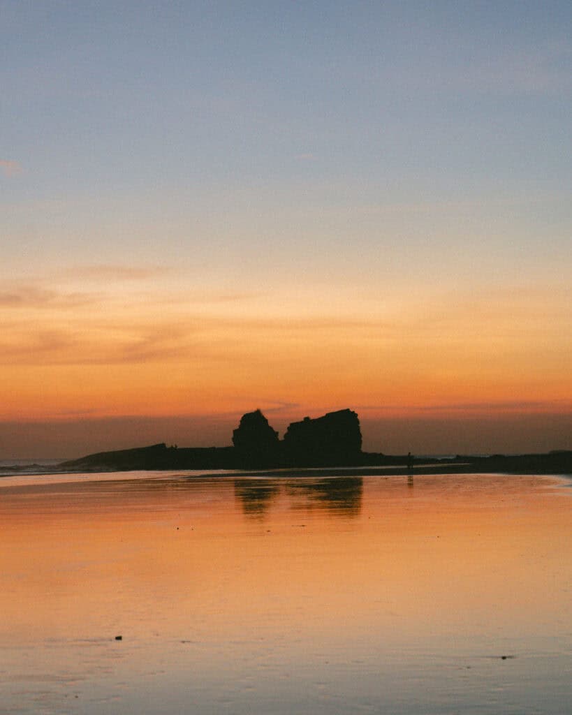 Popoyo, Nicaragua Travel Guide: Surf, Sand and Sunsets 19 A serene sunset view with Magnific Rock reflected in the wet sands, Popoyo, Nicaragua.