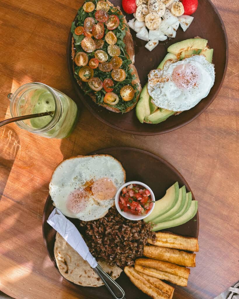San Juan del Sur, Nicaragua Travel Guide: Worth the Hype? 37 A beautifully plated breakfast with sunny-side-up eggs, fried plantains, rice and beans, and avocado slices at Ding Repair Cafe in San Juan del Sur.