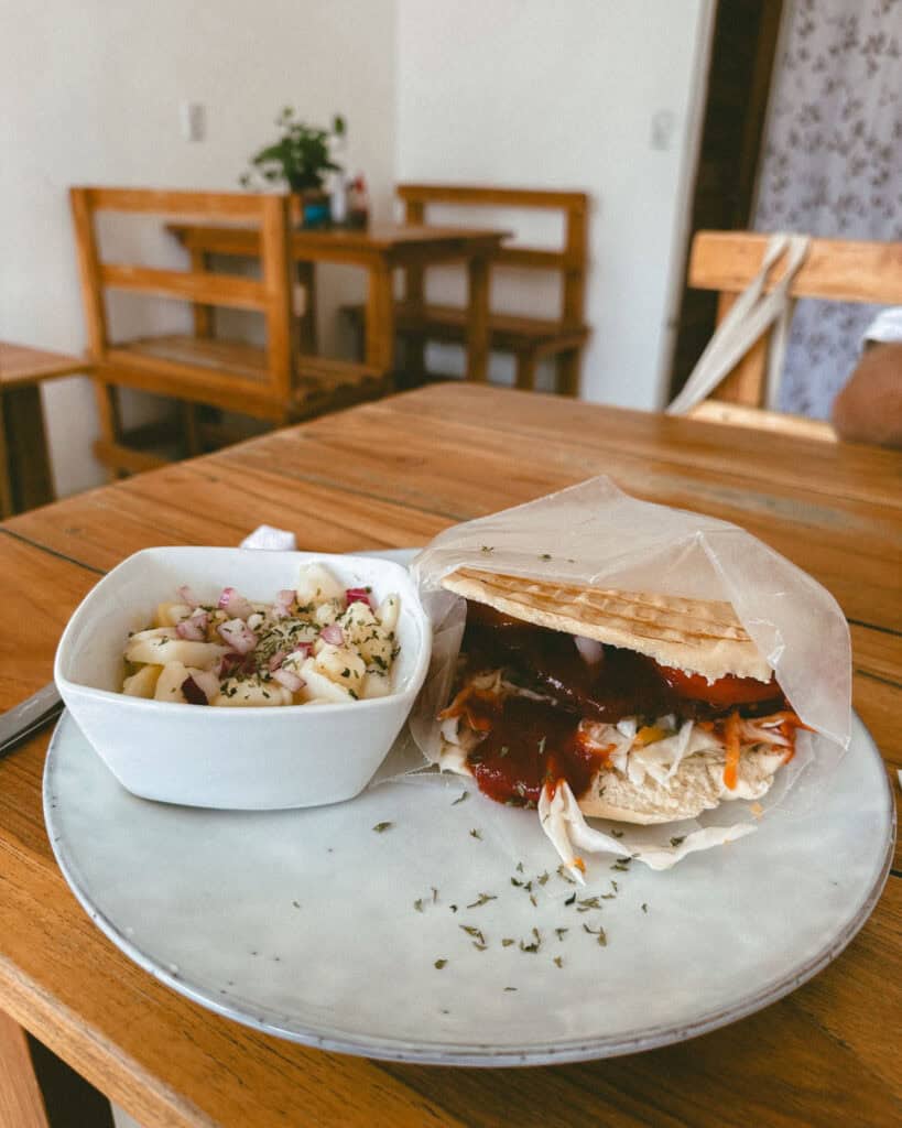 San Juan del Sur, Nicaragua Travel Guide: Worth the Hype? 39 Plate of pita bread filled with chicken schnitzel, fresh coleslaw and barbecue sauce, accompanied by a side of salad at Sansiba in San Juan del Sur.