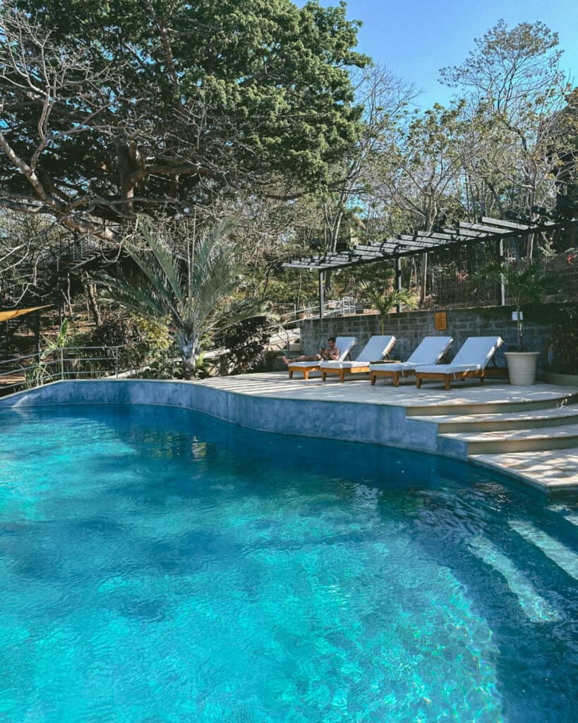 San Juan del Sur, Nicaragua Travel Guide: Worth the Hype? 12 Another peaceful view of TreeCasa Resort’s inviting pool area, with tropical trees and lounging spaces for guests.