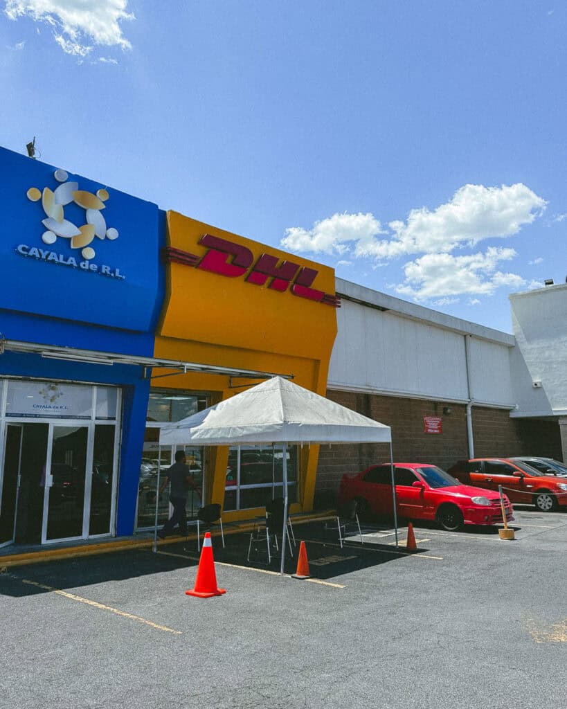 No Drones in Nicaragua: Our Solution 3 The front a DHL store in El Salvador with a yellow exterior, sending a drone to Costa Rica as drones are not allowed in Nicaragua.
