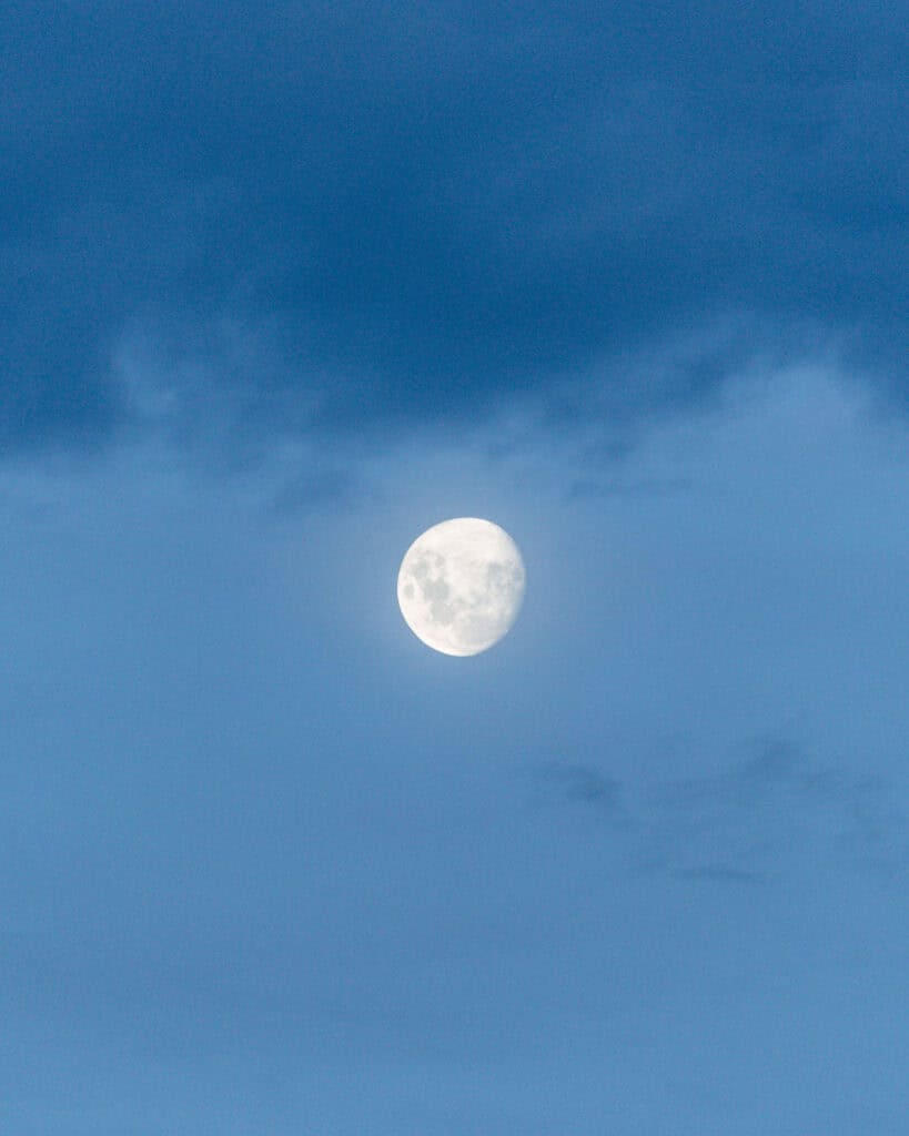 Valle Chacabuco Sector Guide: Parque Nacional Patagonia, Chile 23 A nearly full moon glows brightly against a dusky blue sky, with soft clouds partially framing it