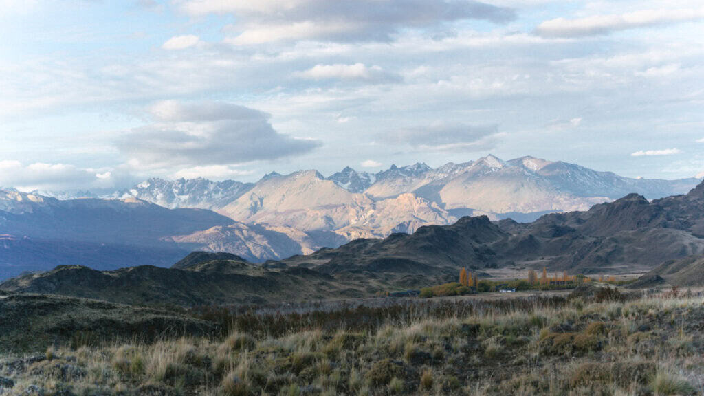The Carretera Austral, Chile: Everything You Need to Know 73 Wide landscape view of the Valle Chacabuco area with snow-dusted peaks in the distance and golden autumn trees marking the location of the visitor center
