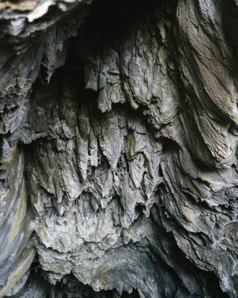 How to Visit the Marble Caves in Chile: Worth the Journey? 19 Abstract interior shot of the Marble Caves in Puerto Río Tranquilo, focusing on jagged rock formations resembling draped stone layers
