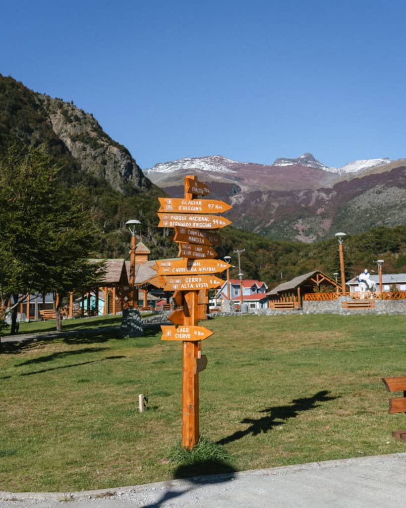 Villa O'Higgins, Chile Guide: End of the Carretera Austral 19 Wooden signpost with arrows pointing to nearby attractions like Glaciar O’Higgins, Lago Ciervo, and the start of the Carretera Austral