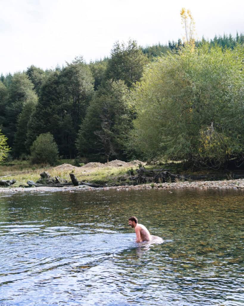Camping on the Carretera Austral, Chile: Our Tips & Tricks 19 Brayden plunging in to a cold rocky river on the Carretera Austral, Chile
