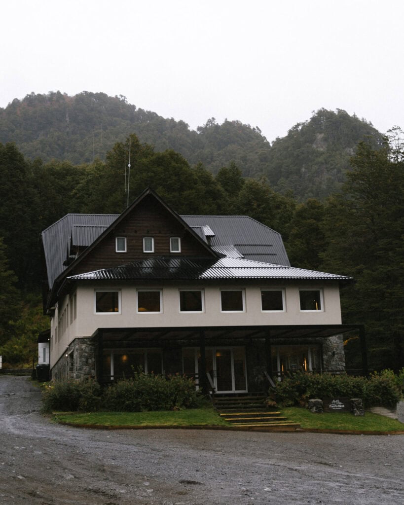 Cruce Andino: The Scenic Route From Chile to Argentina 30 A quaint alpine-style hotel named Puerto Blest sits at the base of misty forested hills in the Andes, its windows warmly lit against a gray sky