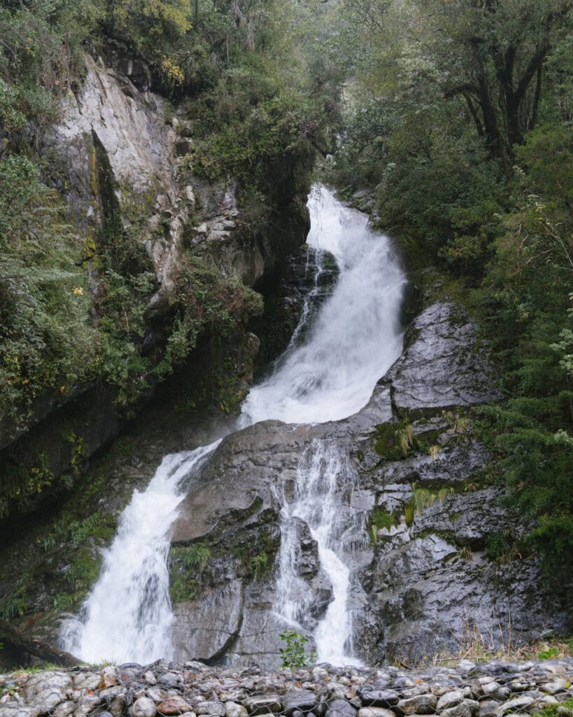 Cruce Andino: The Scenic Route From Chile to Argentina 2 A powerful multi-tiered waterfall crashes over mossy rocks and cliffs surrounded by dense vegetation near Peulla, Chile