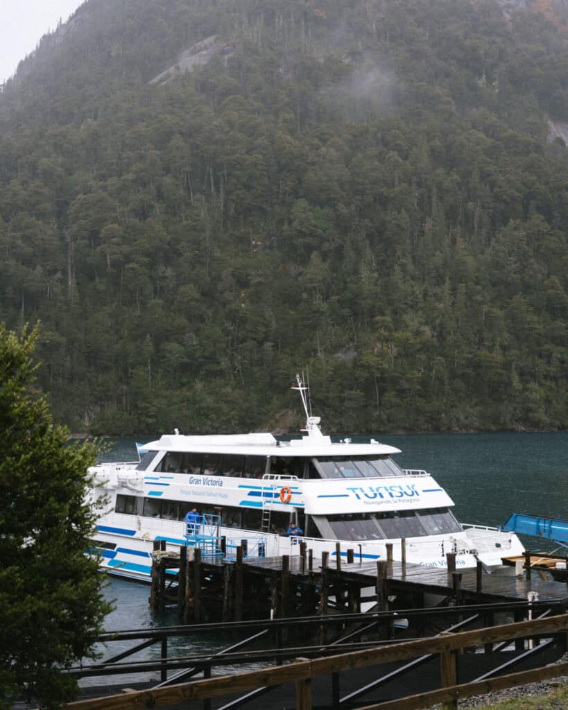Cruce Andino: The Scenic Route From Chile to Argentina 32 A large white catamaran named Gran Victoria is docked at Puerto Blest, with forested hills rising steeply behind it in Parque Nacional Nahuel Huapi