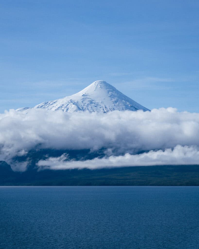 Cruce Andino: The Scenic Route From Chile to Argentina 9 Snow-capped Volcán Osorno rising above a blanket of clouds, viewed from Lago Llanquihue near Puerto Varas on a bright, clear day