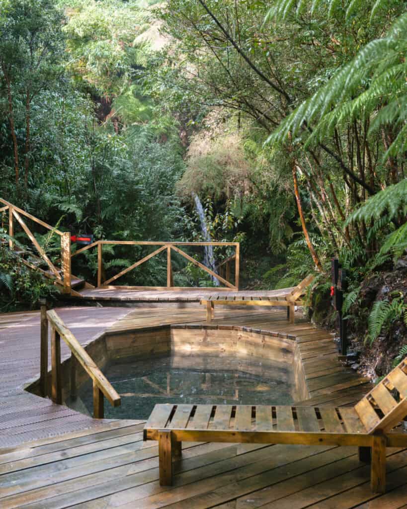 Hornopiren, Chile Travel Guide: Termas, Alerces & Fjords 15 Wooden hot spring pool with surrounding deck and lounge chairs nestled in the forest at Hornopirén, Chile.