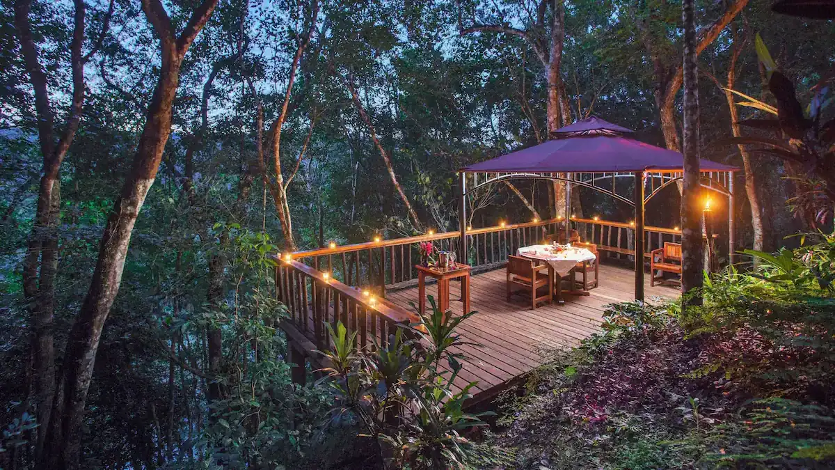 Where to Stay in San Ignacio Belize: Town or Jungle Lodge? 12 A romantic outdoor table set in the evening in the middle of the jungle at Table Rock Jungle Lodge in San Ignacio.